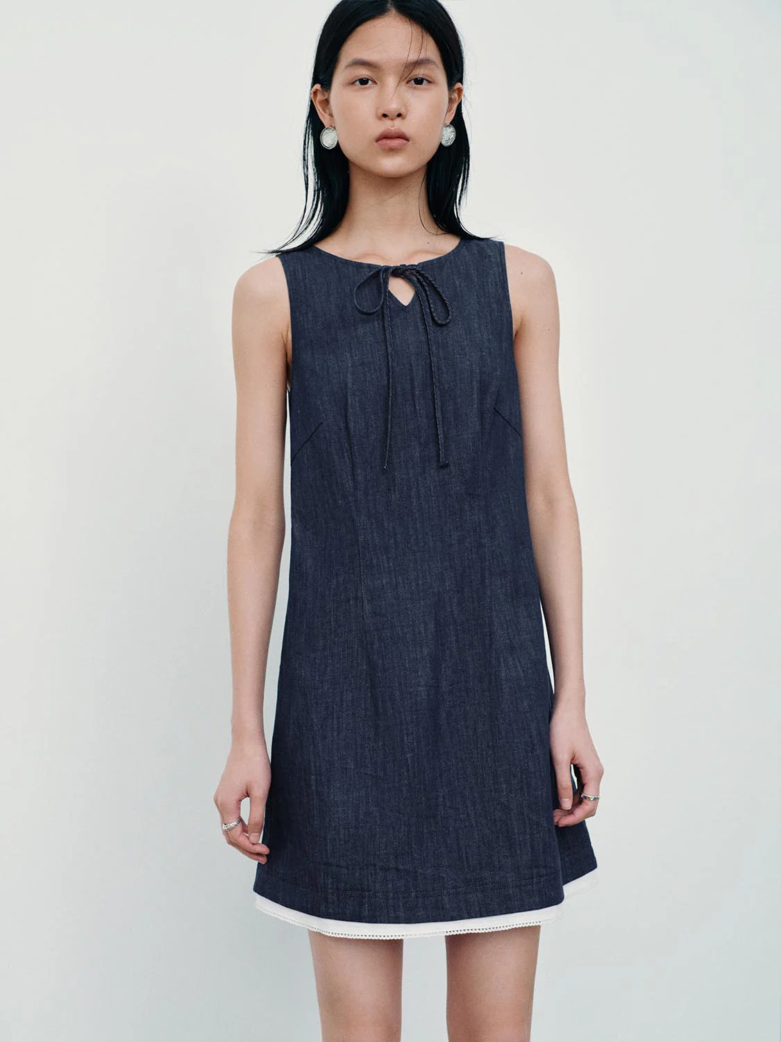 4500-tie-detail-sleeveless-denim-mini-dresses-1.webp Tie Detail Sleeveless Denim Mini Dresses