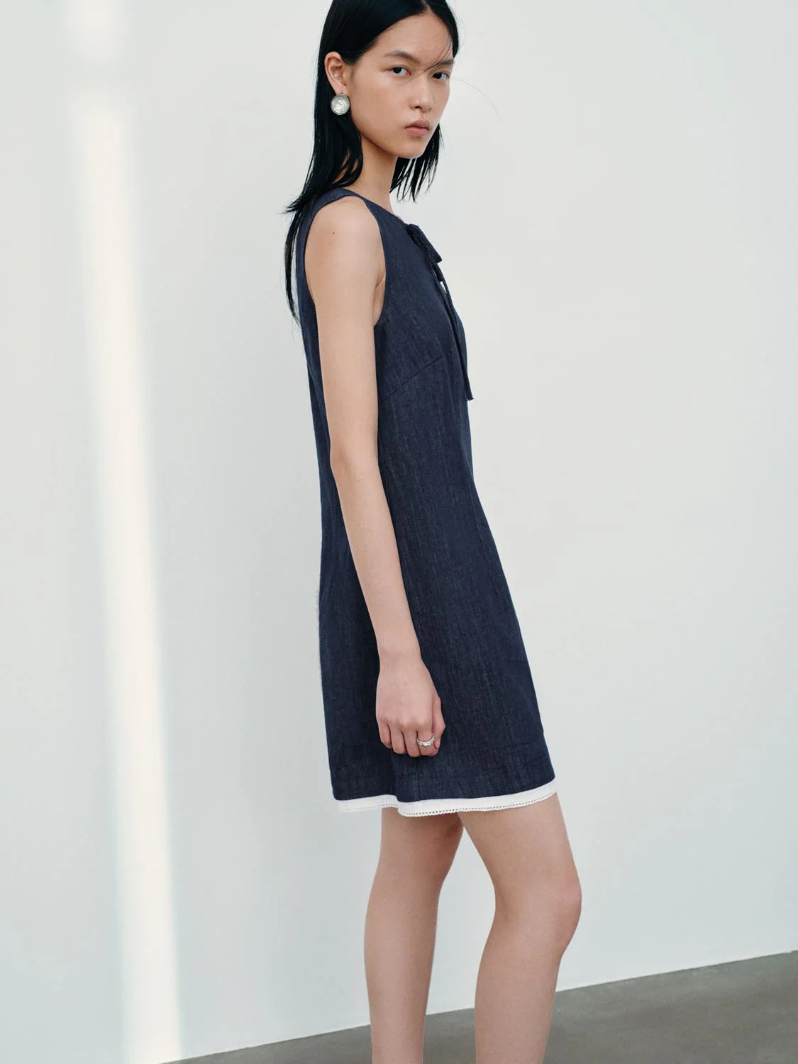 4500-tie-detail-sleeveless-denim-mini-dresses-2.webp Tie Detail Sleeveless Denim Mini Dresses