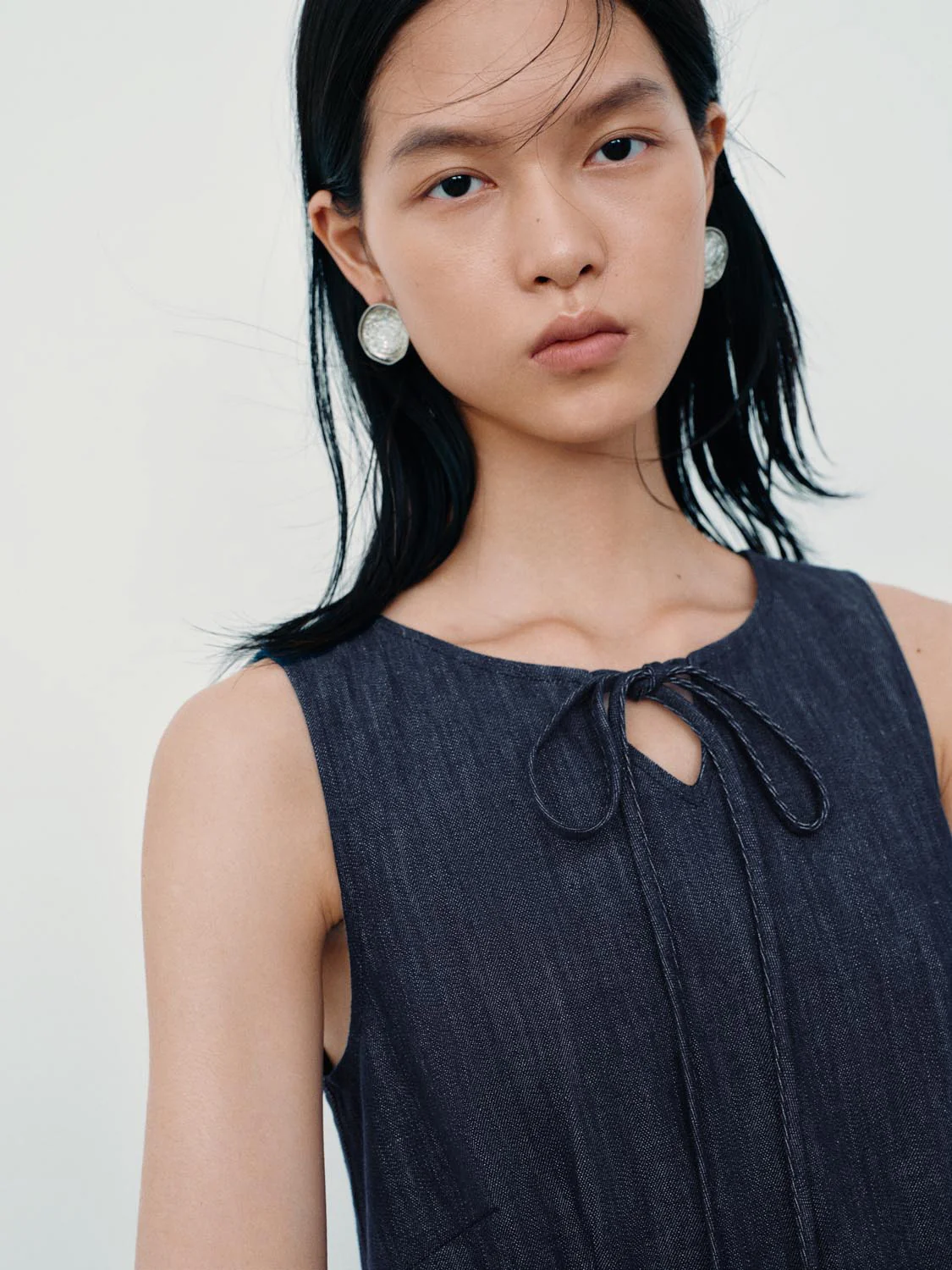 4500-tie-detail-sleeveless-denim-mini-dresses-3.webp Tie Detail Sleeveless Denim Mini Dresses